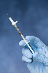 A Medical Worker Holding a Syringe.
