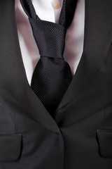 woman's suit and tie