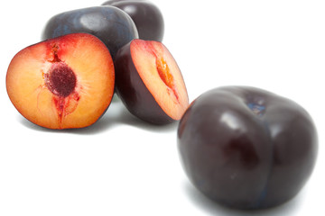 Naklejka na ściany i meble Sliced plums isolated on white