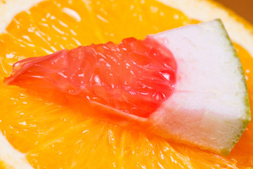 Orange and piece of grapefruit.