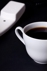 coffee cup and phone receiver