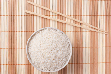 white rice in bowl and chopsticks