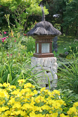 An Asian influenced garden lantern in an informal garden.