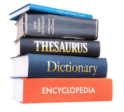 A pile of reference books isolated against a white background