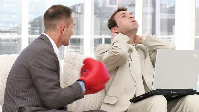 Mature businessman punching his colleague
