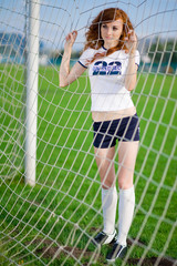 healthy beautiful girl with freckles on soccer field