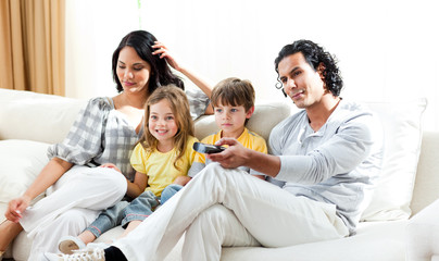 Smiling family watching TV