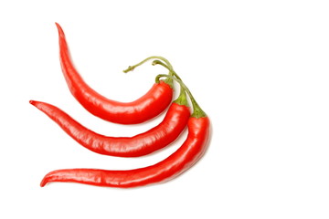 Three red chilli peppers isolated on white background