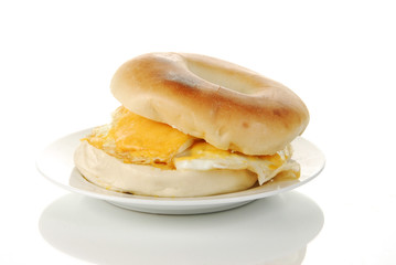 Egg and bagel on a reflective white background
