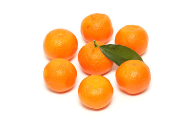fresh tangerine fruits with green leaves isolated on white