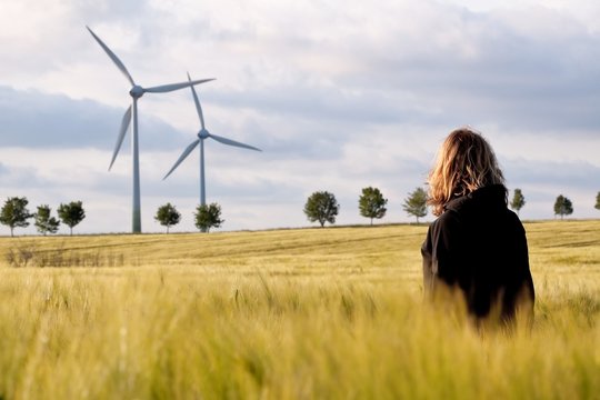 Woman in the barley with windmills