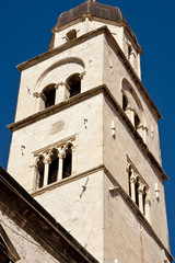 Fototapeta premium An ancient bell tower in Croatia Against a Blue Sky