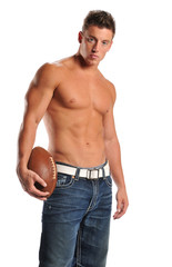 Fototapeta premium Muscular man holding a football