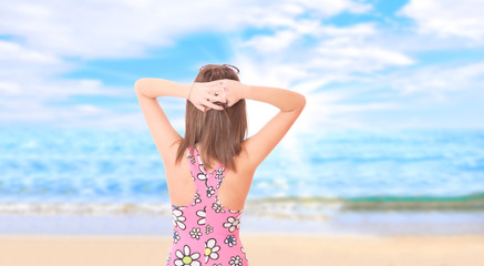 Fototapeta na wymiar Beautiful young woman relaxing by the beach