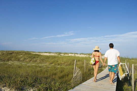 Couple on Beach Boardwalk - Powered by Adobe