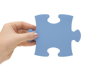 Hand collecting a part of a puzzle