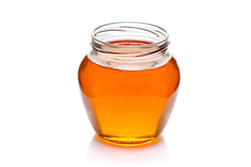 Jar of honey isolated on white background
