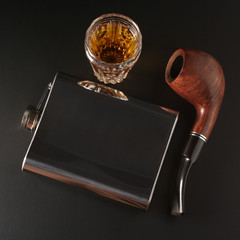 Cognac, flask and pipe