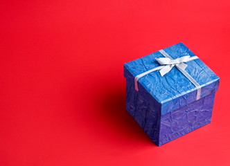 Blue gift on a red background
