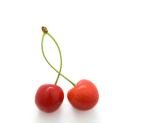 sweet cherry with a green leaf on white background.
