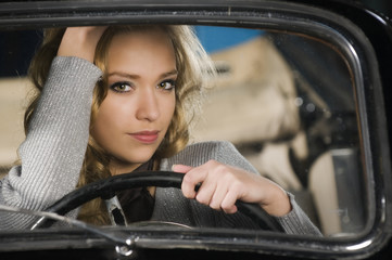 Fototapeta na wymiar beautiful woman in an old car