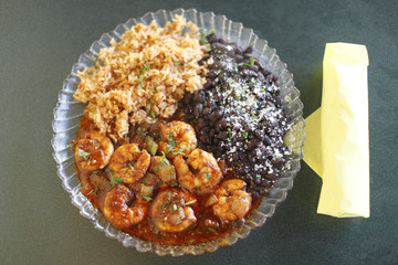 Mexican style shrimp dinner with rice and beans and tortillas