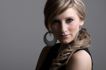 Studio Shot of a Pretty Teenage Girl against Grey Background