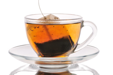 Cup with tea and tea bag on a white background