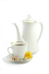 white jug, cup, sugar cane and yellow flower