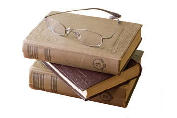 Pile of books with glasses