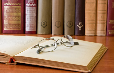 book and glasses in library
