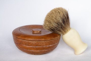 Wooden shaving soap bowl and brush on white