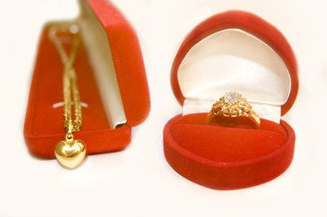 Golden ring with diamond and golden necklace conceptual image.