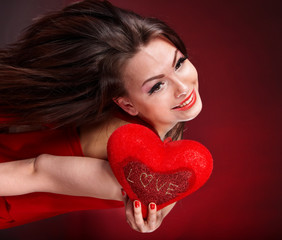 Girl with heart  on red background flying. Valentine's Day
