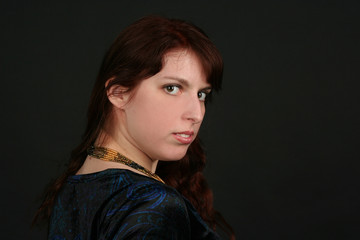 Portrait of young brunette woman isolated on black background