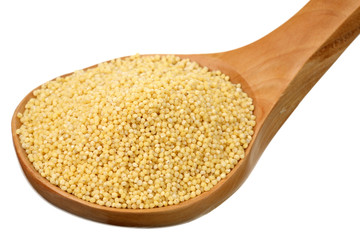Millet in a wooden spoon on a white background