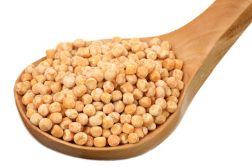 Dry peas in a wooden spoon on a white background