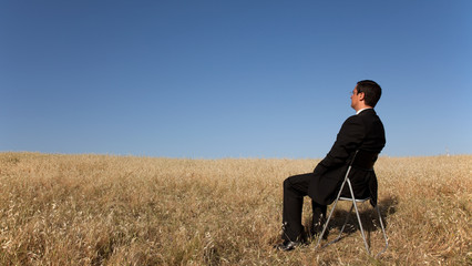 Businessman waiting at the field