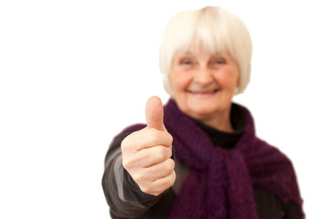 Success - smiling older woman giving you the thumbs up