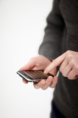 Young male hand writing sms on cellphone