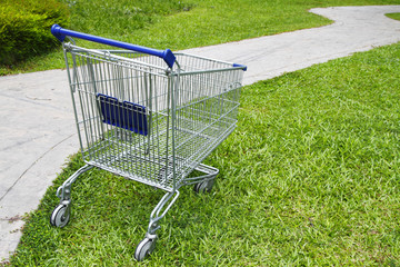 An empty shopping cart at a public park