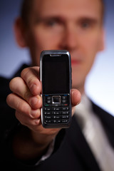 Business man holding a mobile phone