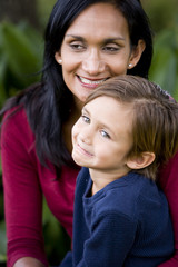 Fototapeta premium Closeup of loving mother with cute mixed-race 5 year old son