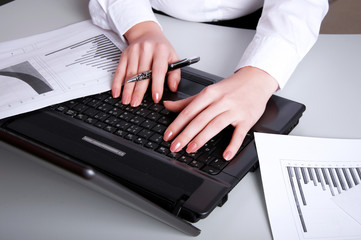 hands of a young girl working on laptop