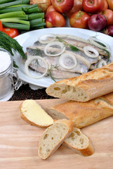 some fresh organic herring on a white plate