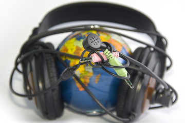 Headset on world globe isolated
