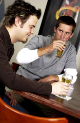 Two men drinking at a bar
