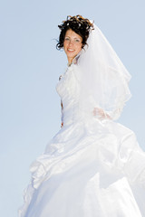 beautiful bride on blue sky background