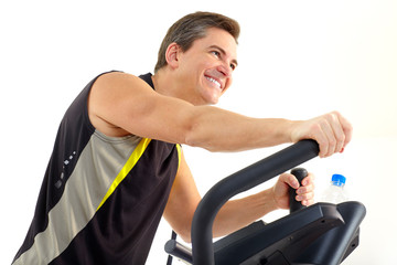 Smiling mature man working out. Isolated over white background.