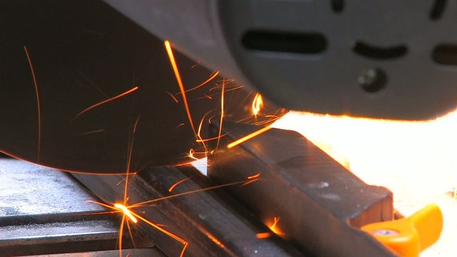 HD Closeup of a metal cutting saw slicing